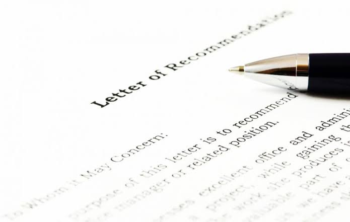 A close-up of a printed letter of recommendation with a pen resting on the page.